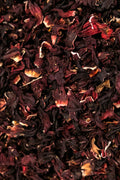 Close up of dried hibiscus flowers with deep red tones, representing natural beauty and refreshing herbal tea.
