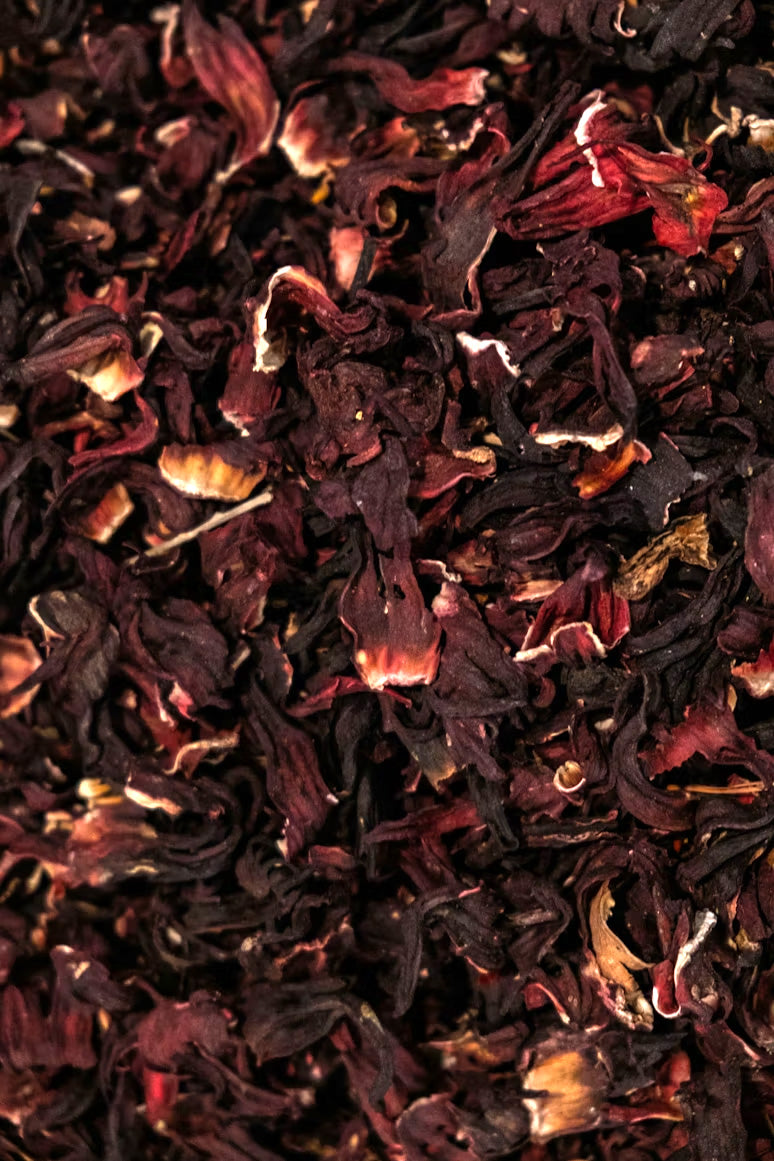 Close up of dried hibiscus flowers with deep red tones, representing natural beauty and refreshing herbal tea.